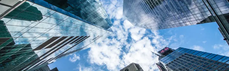 View of skyscrapers from ground level, looking up at the sky