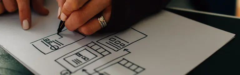 Photo of hand drawing wireframe on paper
