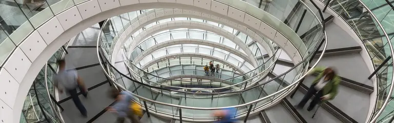 Photo of people moving down a circular stairwell