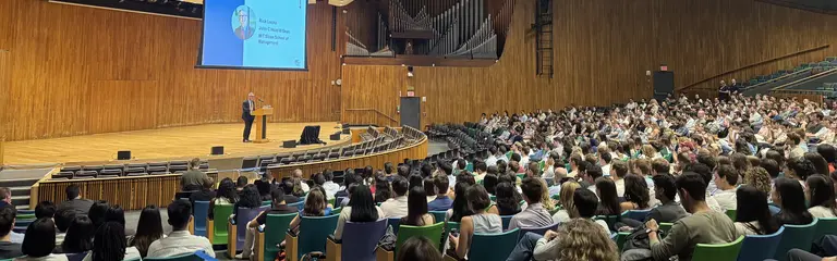 Taken from the back of an auditorium full of students, Dean Rick Locke speaks at a podium