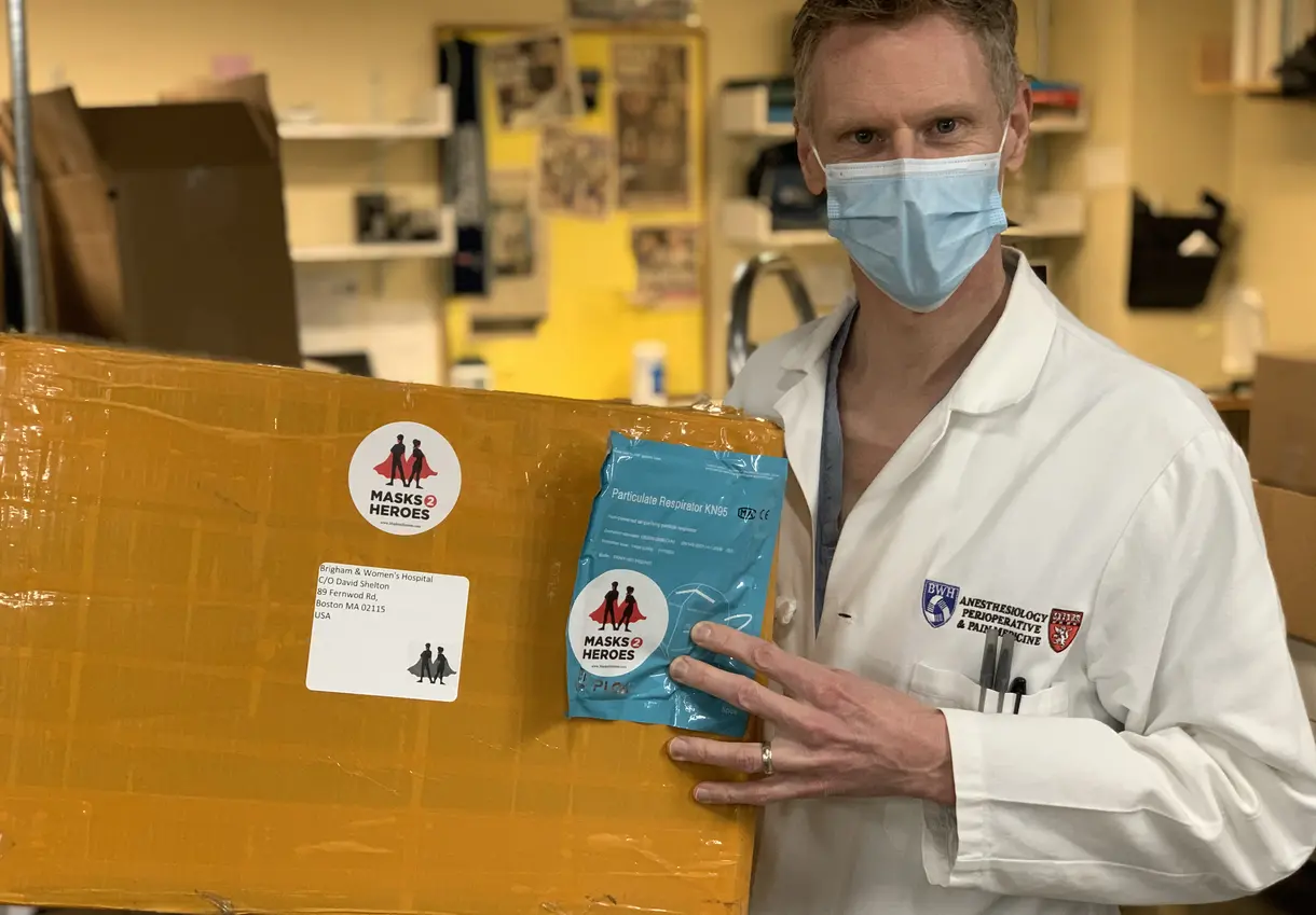 BWH healthcare worker with Masks 2 Heroes donation box.