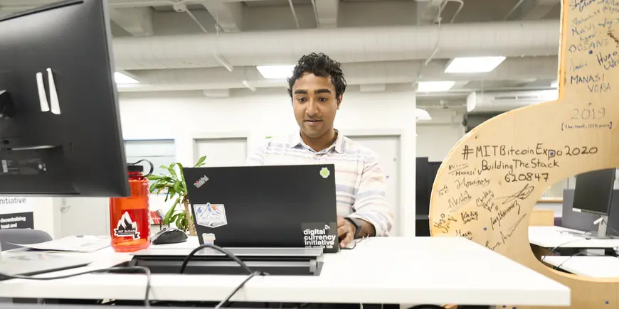 Nikhil sitting behind his laptop