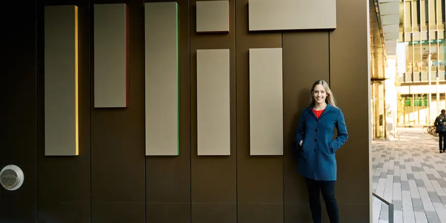 Elisa poses in front of her student dorm