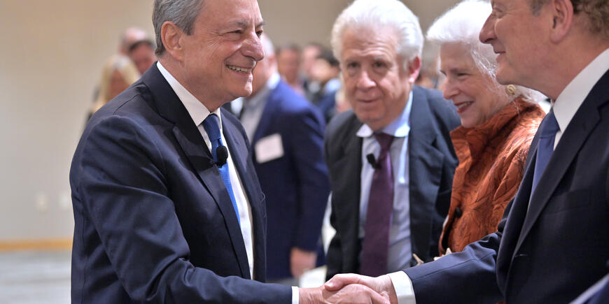 Image of Bob Merton and Mario Draghi shaking hands