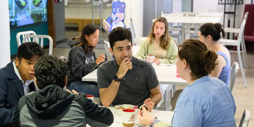 People talk while eating lunch together