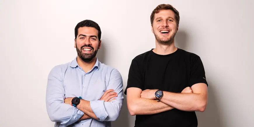 Two men pose for a photo