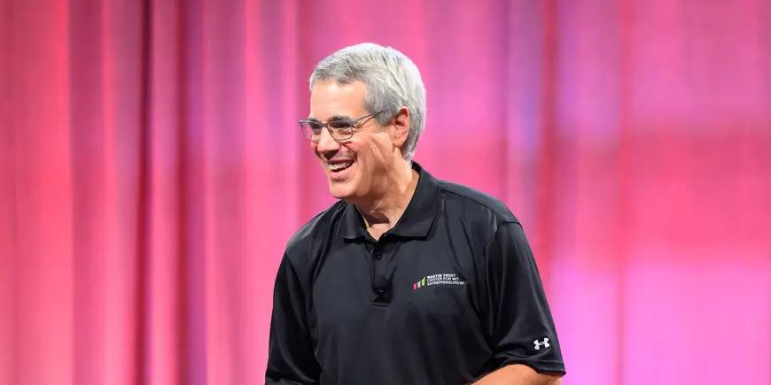 Presenter smiles at the audience