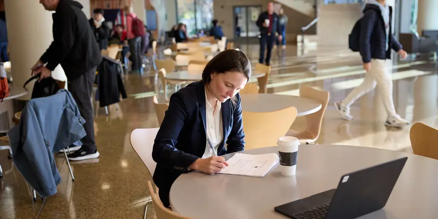 Jocelyn, a student, sitting in the cafeteria