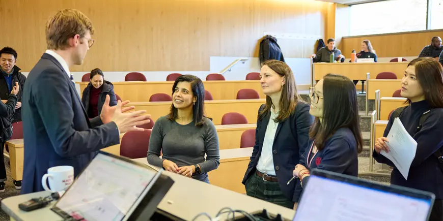 Jocelyn and her fellow students ask the professor questions.