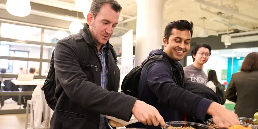 Jack O'Brien and his friend help themselves to a buffet lunch.
