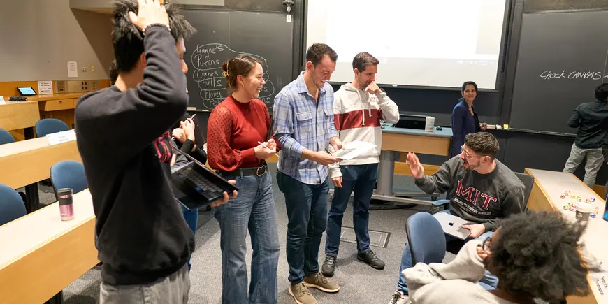 MBA students work in a group to solve a problem.