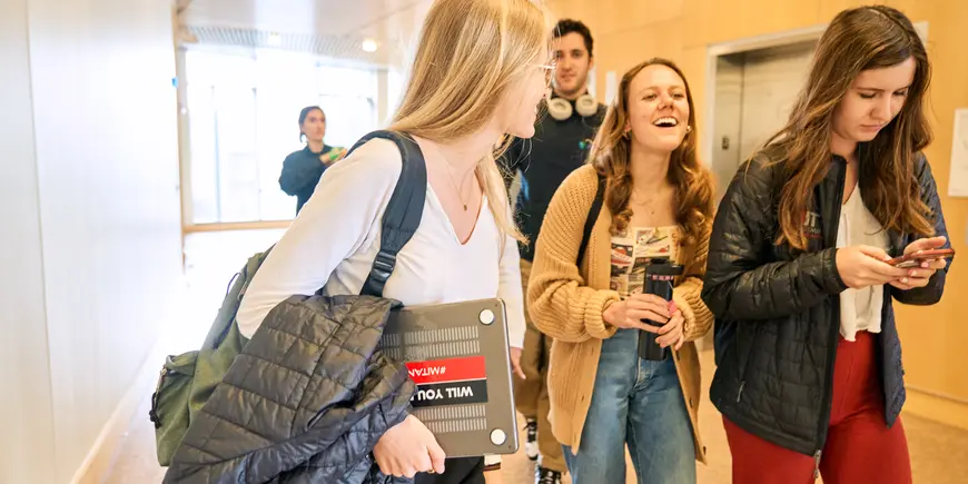 Anne Buisson chats with her friends in the hall.