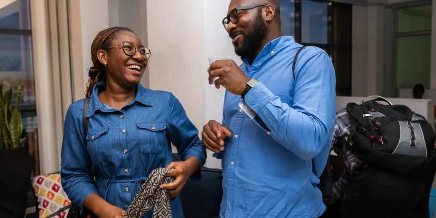 Photo of man and woman laughing while in conversation