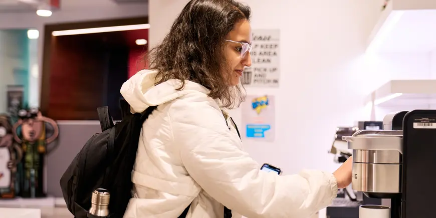 Khushi Pathak grabs a cup of coffee.