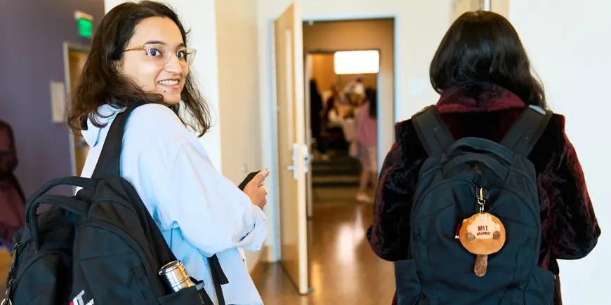 Khushi Pathak walks down the hallway with a friend.