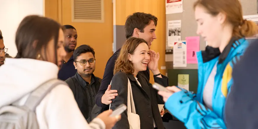 Benedetta Magni walks through a crowded hallway on campus.