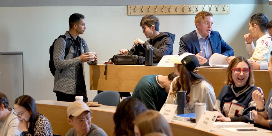 LGO student Abhi Rao chats with classmates in a classroom. 