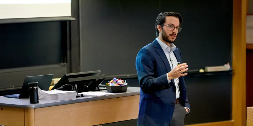 Assistant Professor Benjamin Vatter lectures a class.