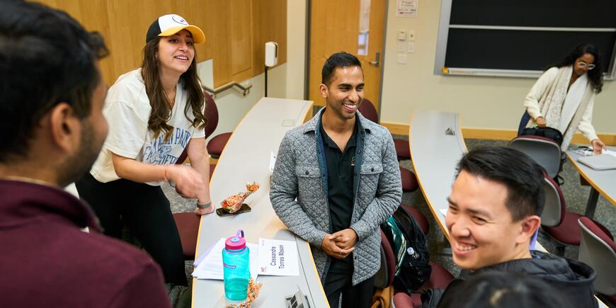 Abhi Rao talks with classmates in a lecture hall