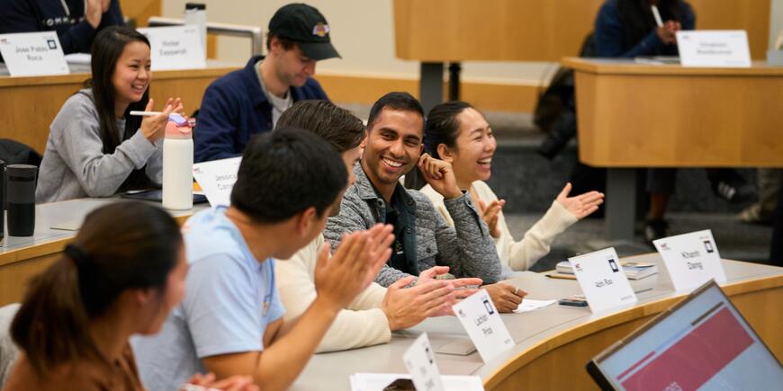 LGO Student Abhi Rao sits in a classroom talking with other students