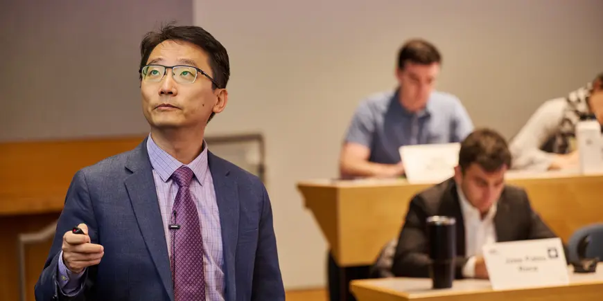 Associate Professor Andy Sun lectures to a class of MBA students.