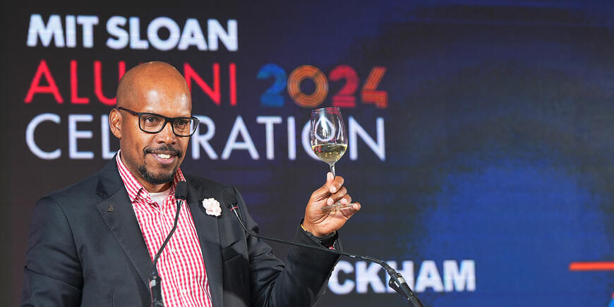 A man raises his glass in toast