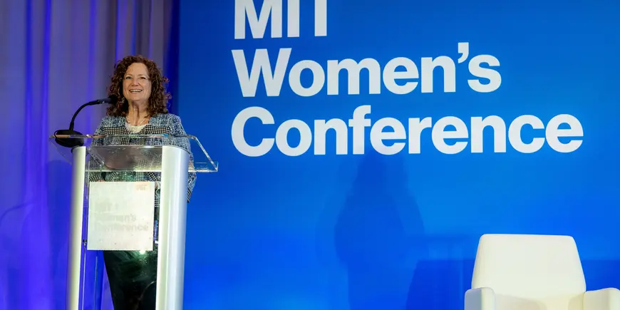 Woman speaks at podium at event