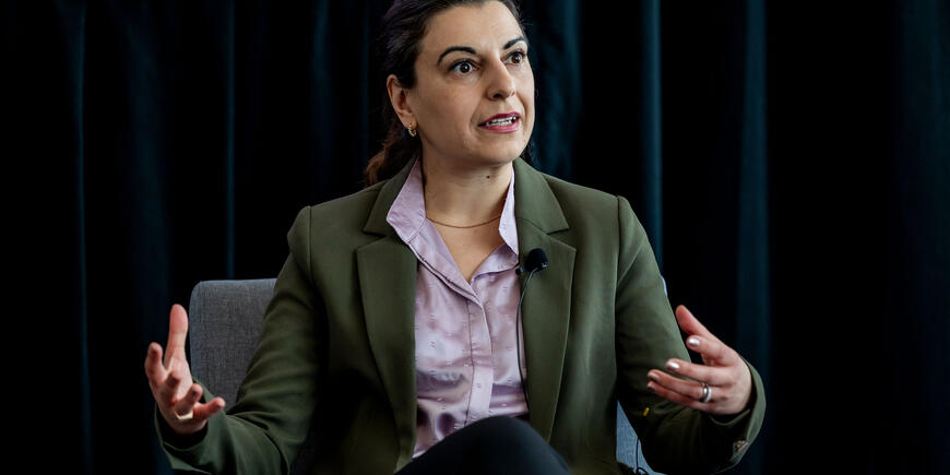 Woman speaking on panel at event