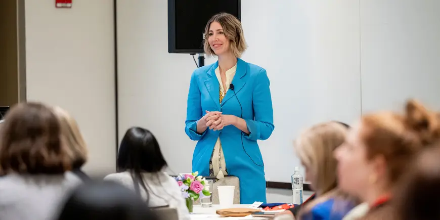 Woman standing and addressing audience
