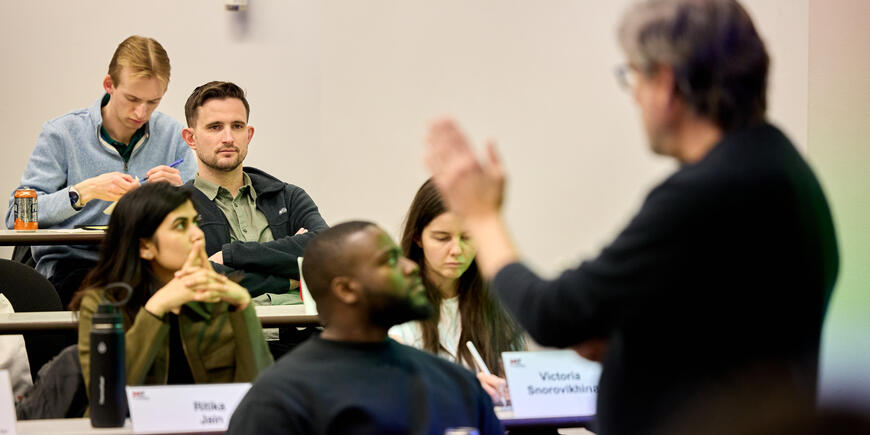 David Brown listens to a professor lecture in a classroom. 