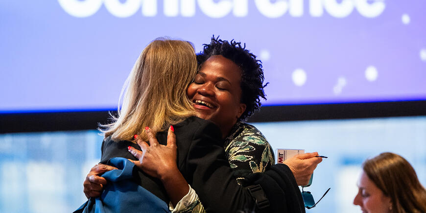 Two women embrace