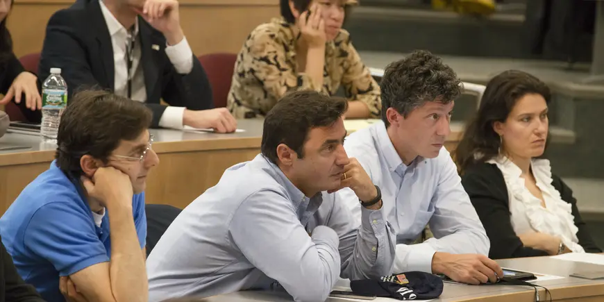 Rows of attentive people in a classroom