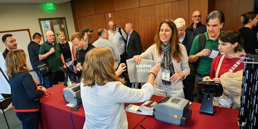 A group of people check in at an event