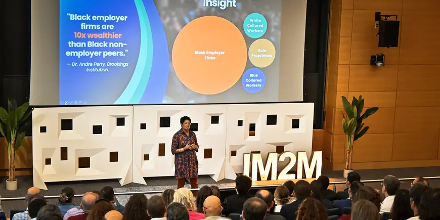 A woman speaks to an audience