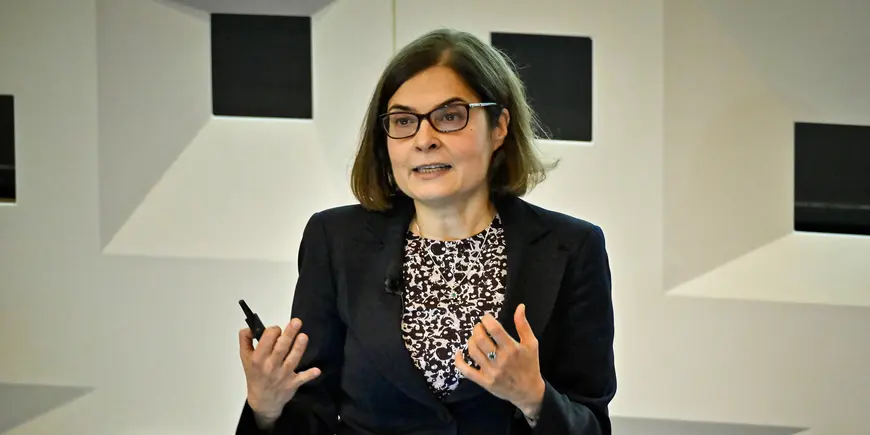 A woman speaks to an audience