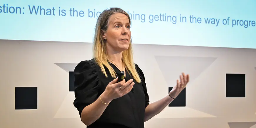 A woman speaks to an audience
