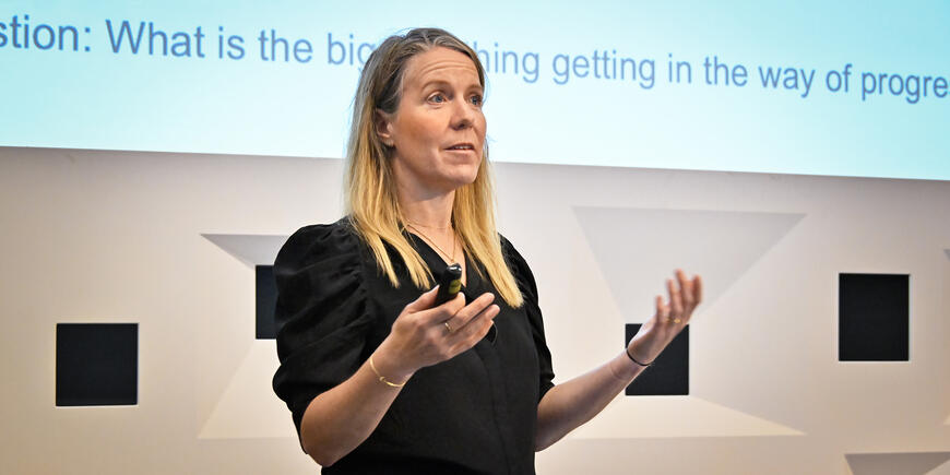 A woman speaks to an audience