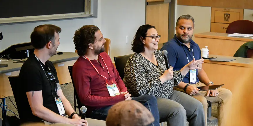 Four panelists speak to an audience