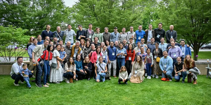 A large group poses for a photo outside