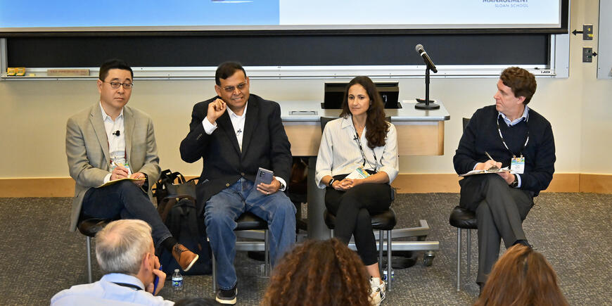 Four panelists speak to an audience