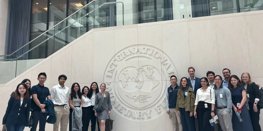 Trek members in front of the IMF Sign