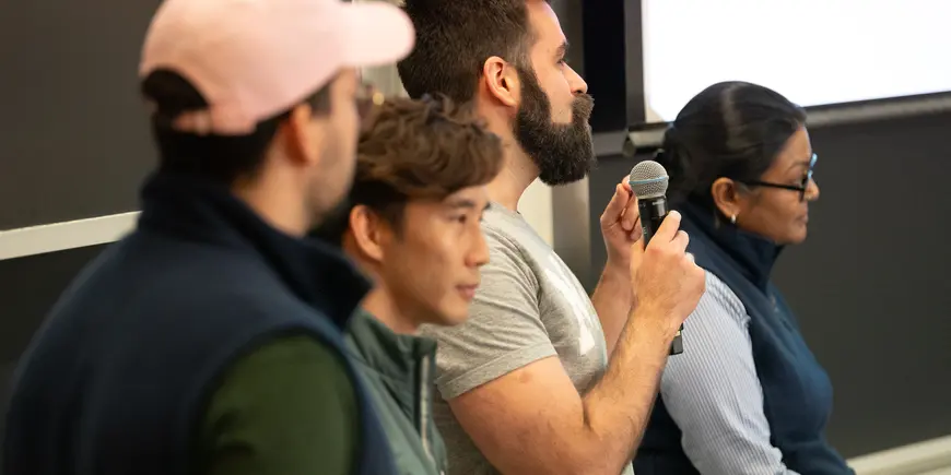 Closeup of Hackathon 2024 students presenting in front of a blackboard