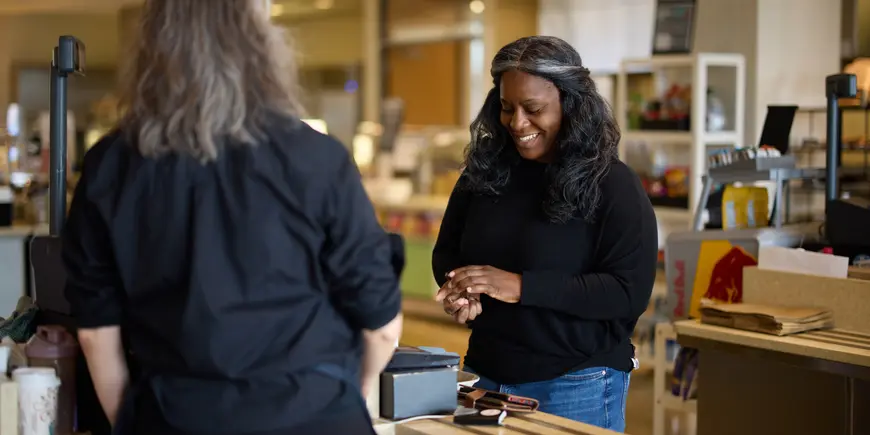 Alecia Asiamigbe purchases a coffee from the MIT Sloan Cafe