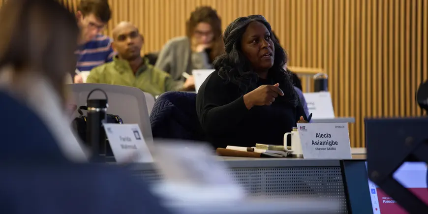 Alecia Asiamigbe sits in a lecture hall. She is speaking as if she has just answered a question.