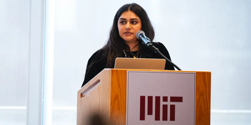 Student standing at MIT Podium