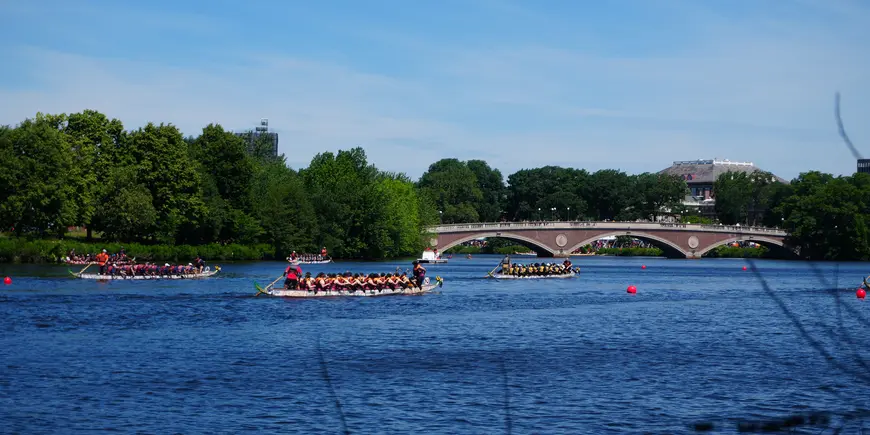 Several boats race on the Charles River