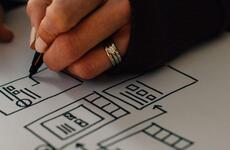 Photo of a person drawing website wireframe.