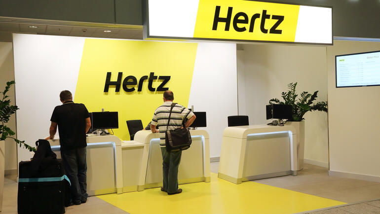 Hertz Car Rental customer kiosk with people 