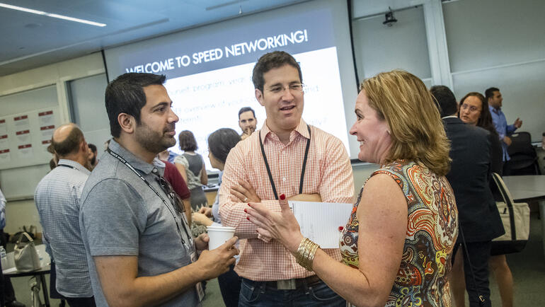 MIT Sloan alumni mingling at reunion speed networking event