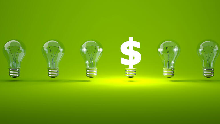 5 lightbulbs next to a lit-up dollar sign, representing venture capital funding new ideas